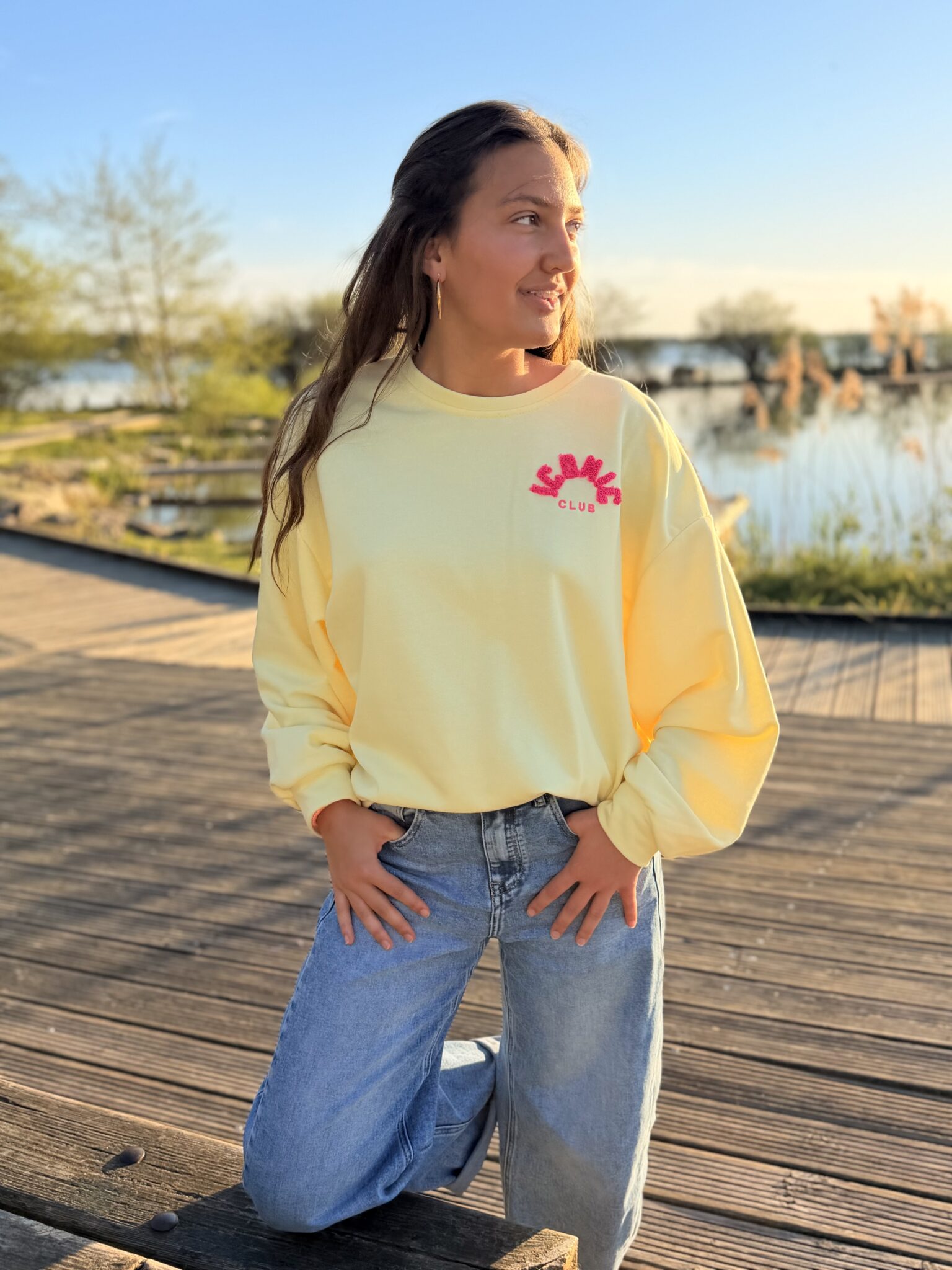 femme brune porte un sweat avec inscription iconic devant et derrière