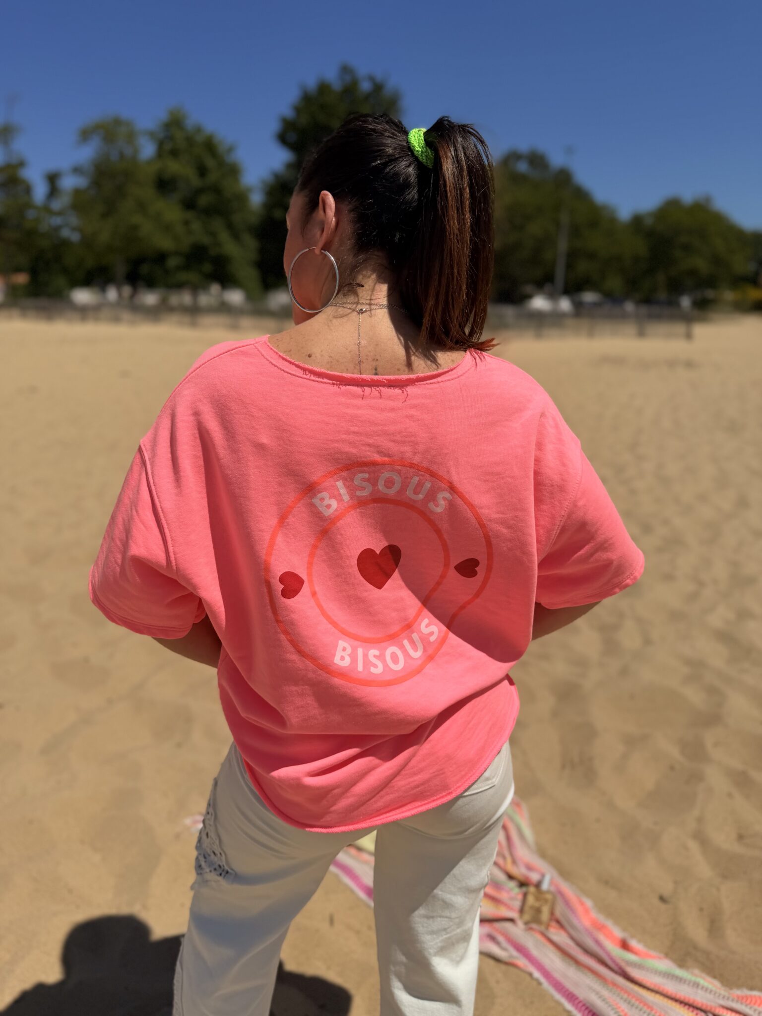 femme brune porte t-shirt oversize avec imprimé coeurs écriture bisous