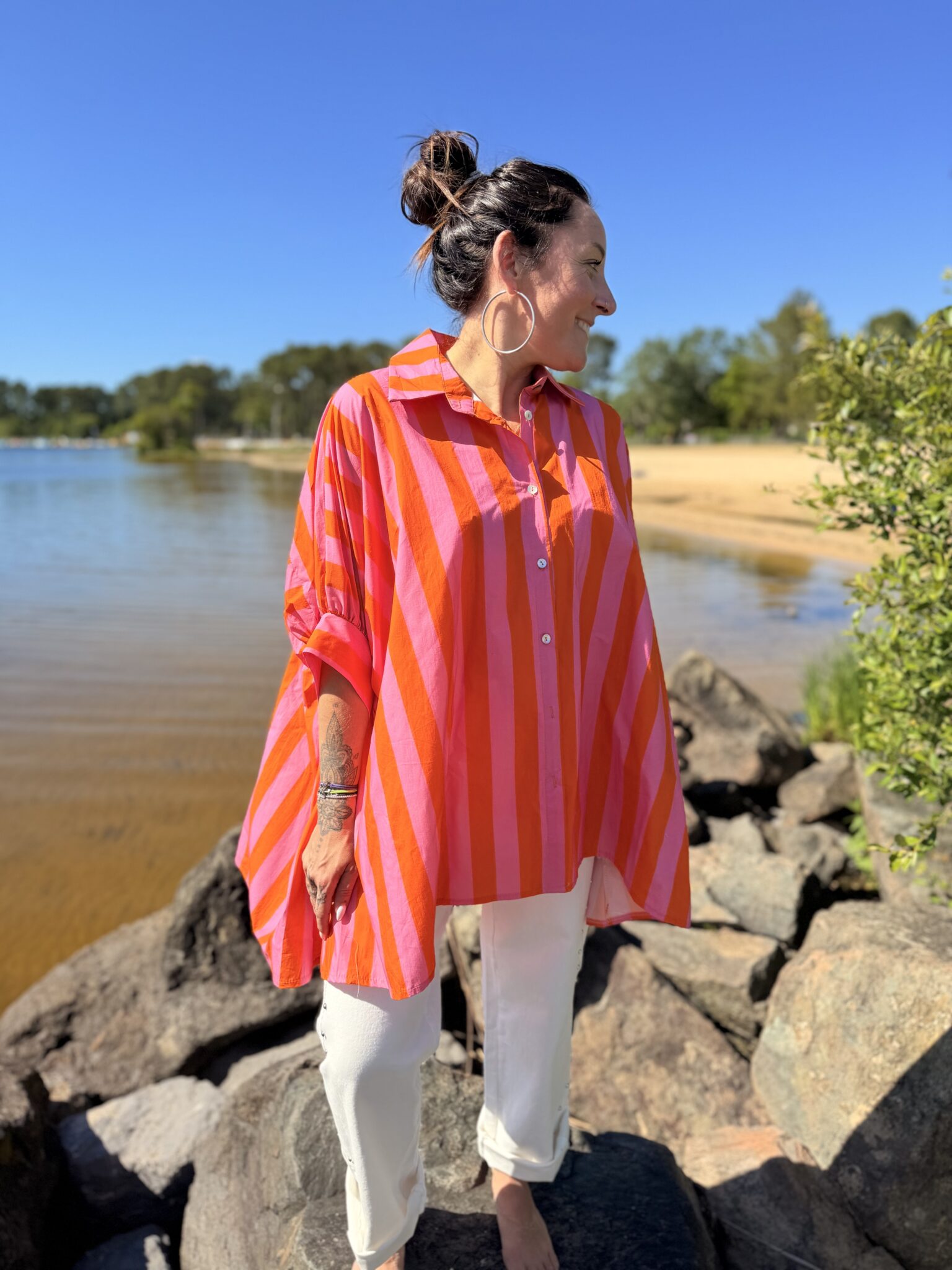 femme brune portant chemise rayée rose orange